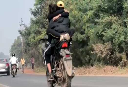 We both will love openly... Romance of the loving couple on the road, arm in arm on the bike