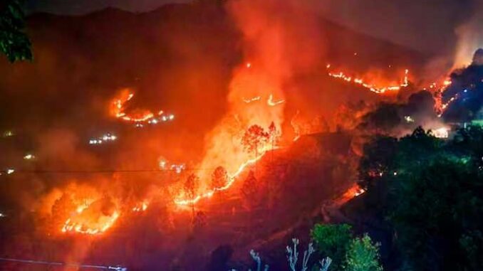 Fire in the forests of Nainital, threat to residential areas, water spraying from Air Force's MI-17