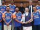 Why did PM Modi hold Rohit-Dravid's hands instead of the trophy during the photo session?